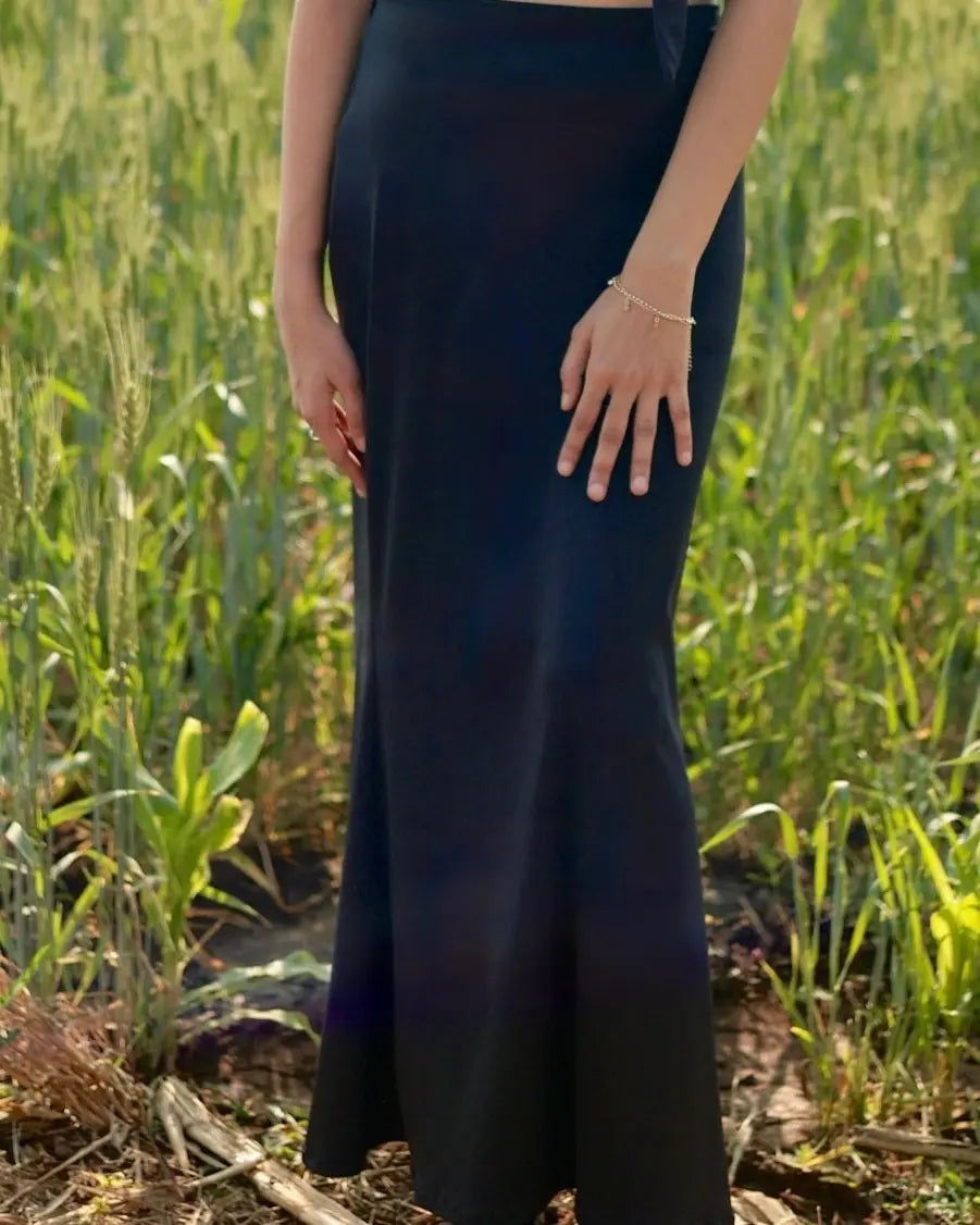 Model wearing black long bodycon skirt