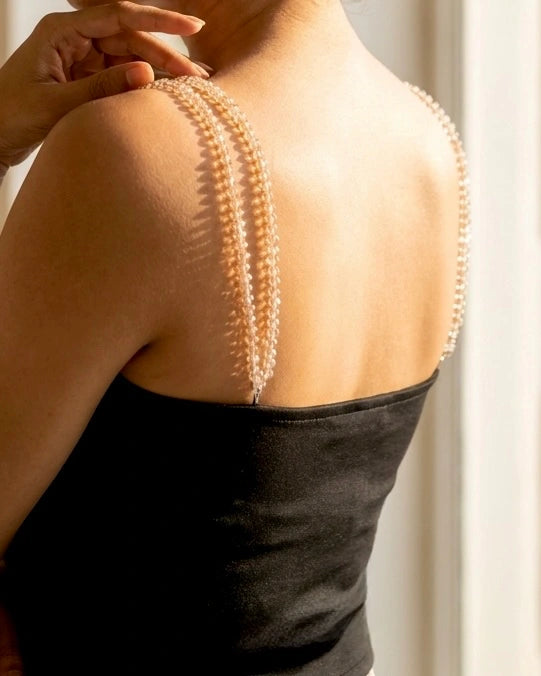 Model wearing black tube top sweetheart neckline with detachable beads accessories of shoulder straps , back 