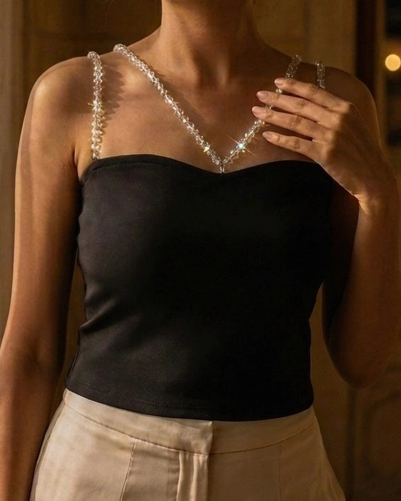 Model wearing black tube top sweetheart neckline with detachable beads accessories of shoulder straps In dark
