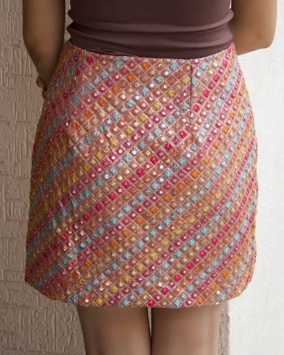 Back view of dusty pink party wear mini skirt with side zip and sequin embroidery