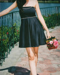Model wearing Black mini tube dress with detachable beads accessories of shoulder and waist belt
