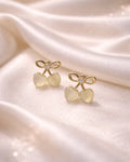 Cherry shaped earring studs of golden colour with golden diamonds