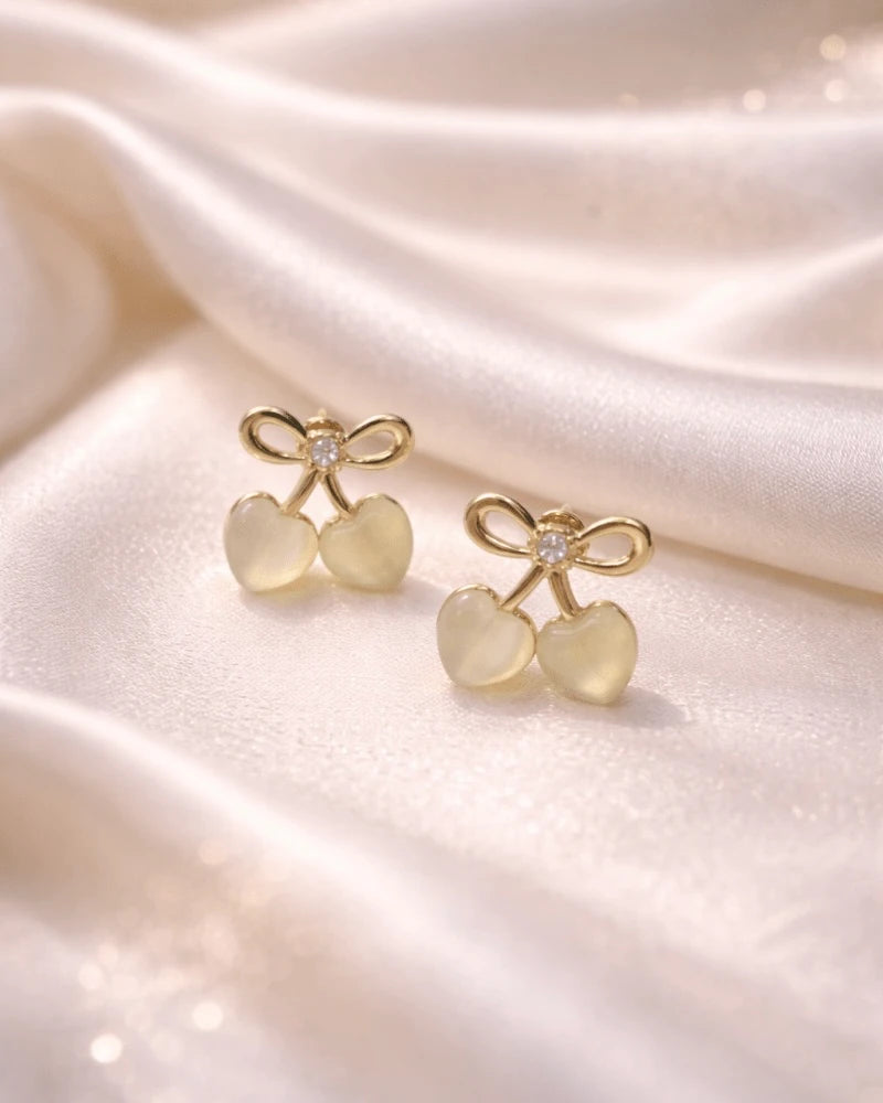 Cherry shaped earring studs of golden colour with golden diamonds