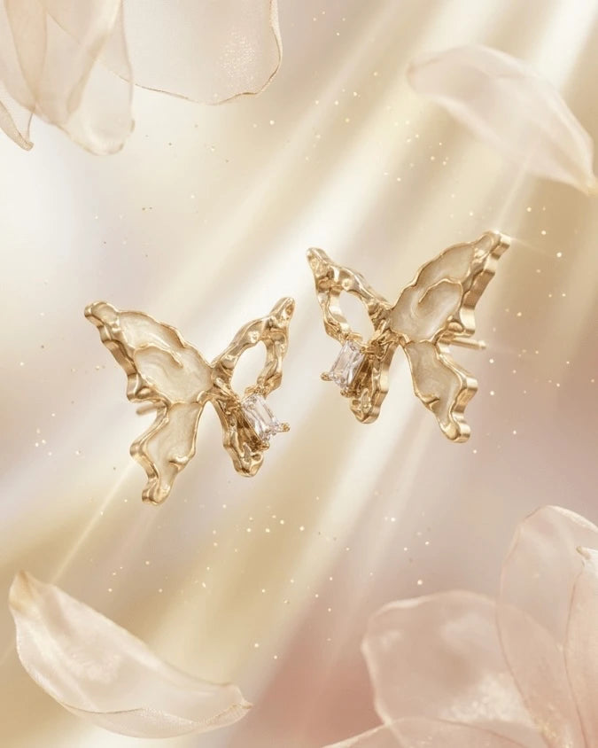 Golden butterfly shaped earring studs with white colour
