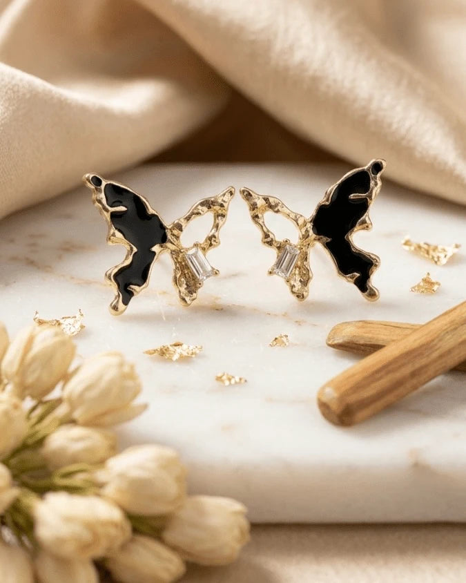 Golden butterfly shaped earring studs with black colour