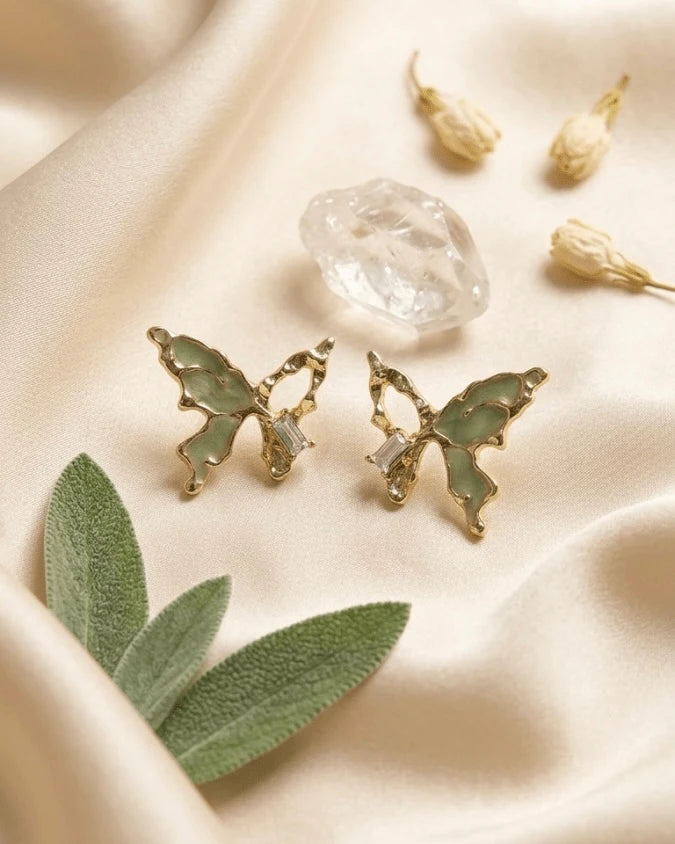 Golden butterfly shaped earring studs with green colour