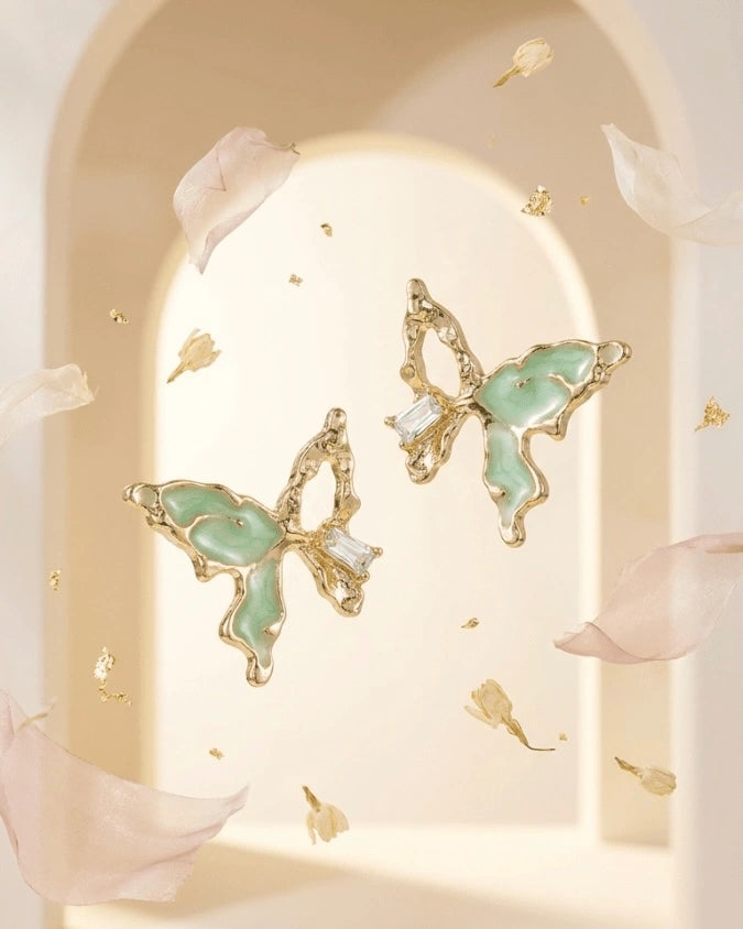 Golden butterfly shaped earring studs with light green colour