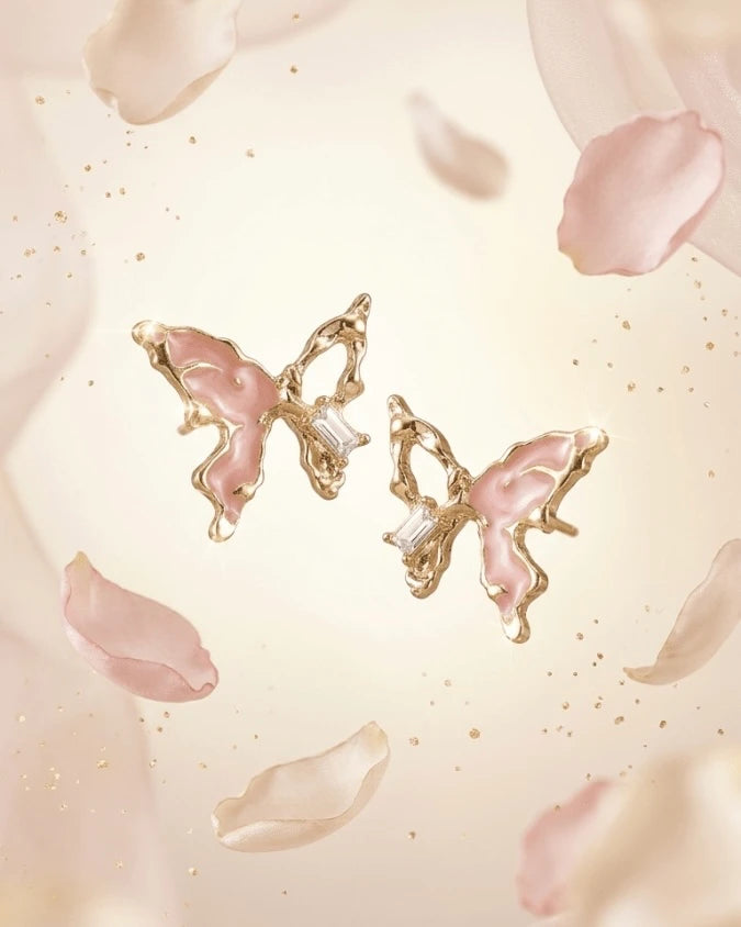 Golden butterfly shaped earring studs with light pink colour