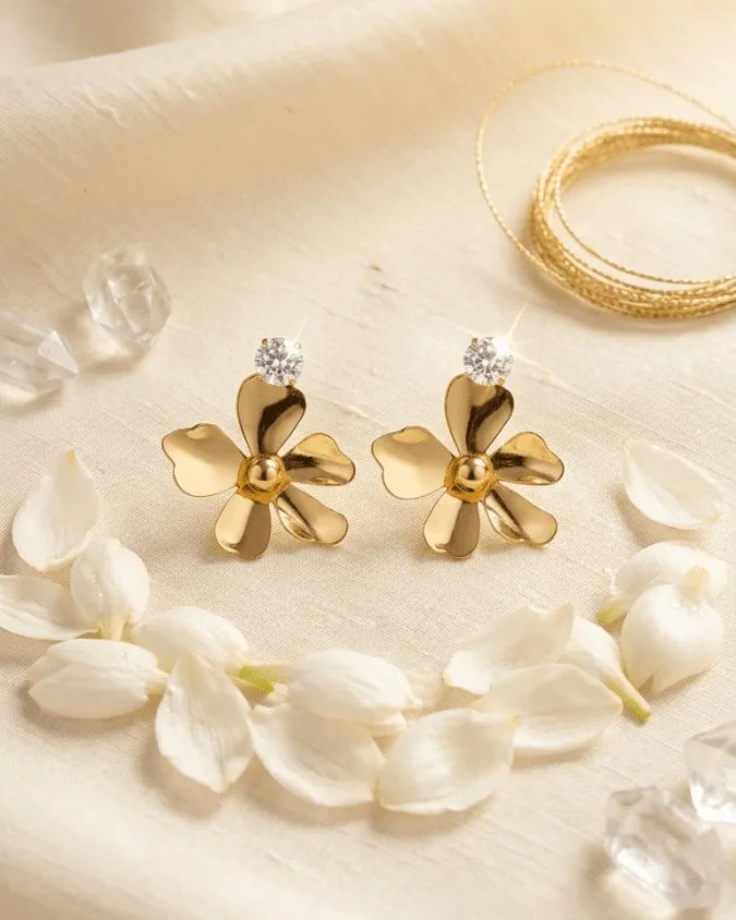 Golden colour daisy flower type asymmetrical flower metal shape with diamond on top of earring