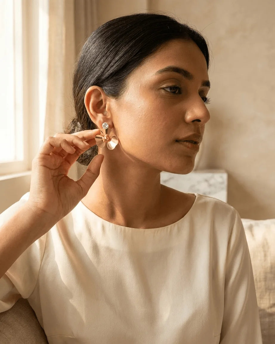 Model wearing Golden colour flower shape earring , affordable earring online India