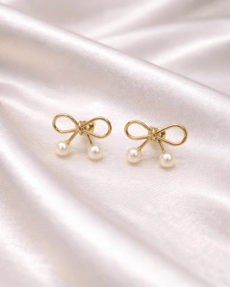 Golden colour Earring stud with bow style with pearl on bottom of it