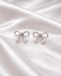Silver colour Earring stud with bow style with pearl on bottom of it