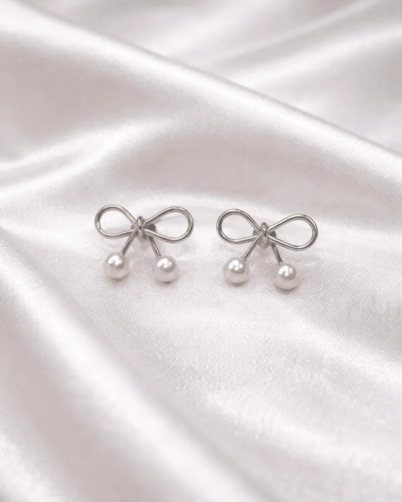 Silver colour Earring stud with bow style with pearl on bottom of it