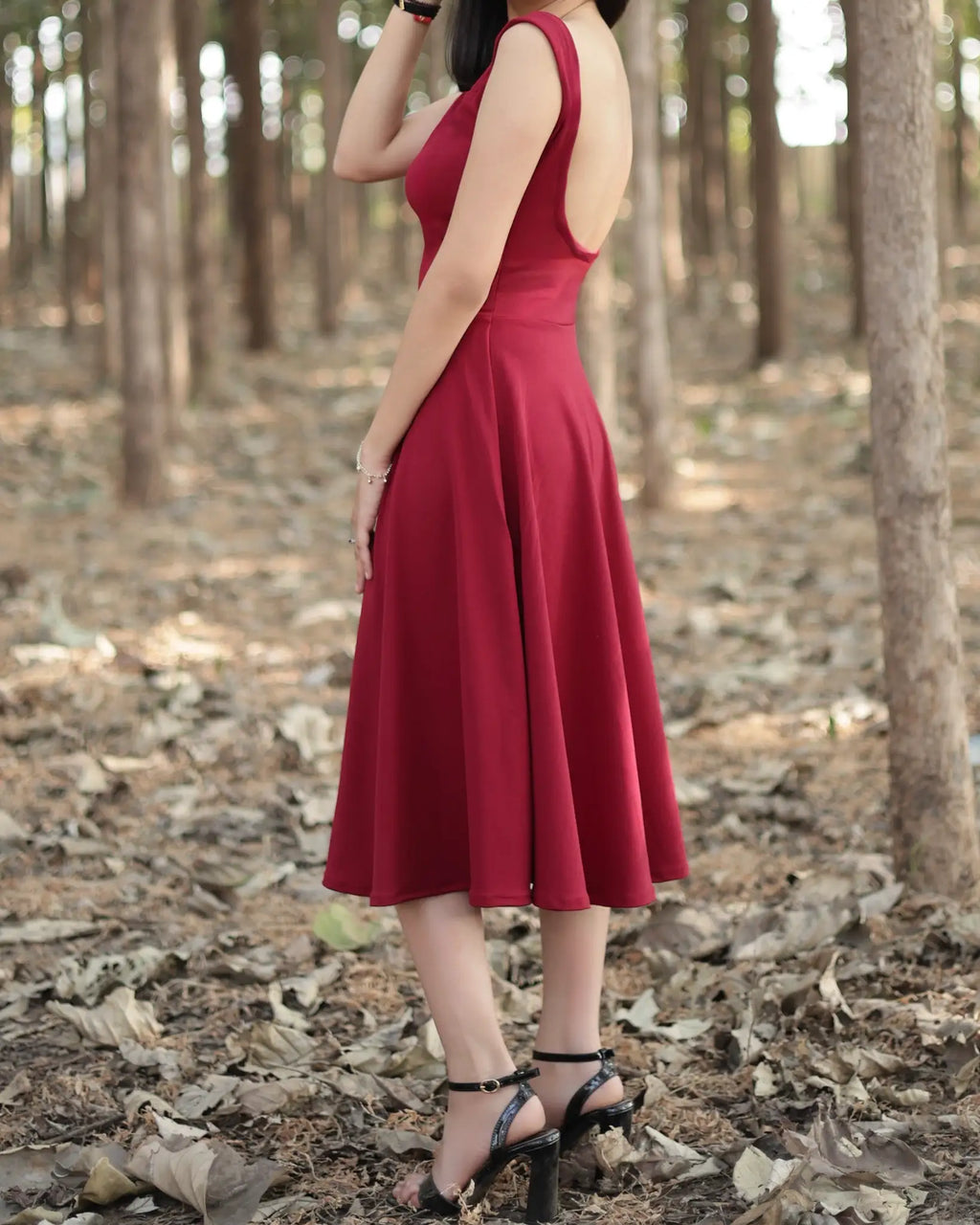 Maroon calf length dress with square neck and backless pattern with sleeve less, circular bottom dress Side pose image