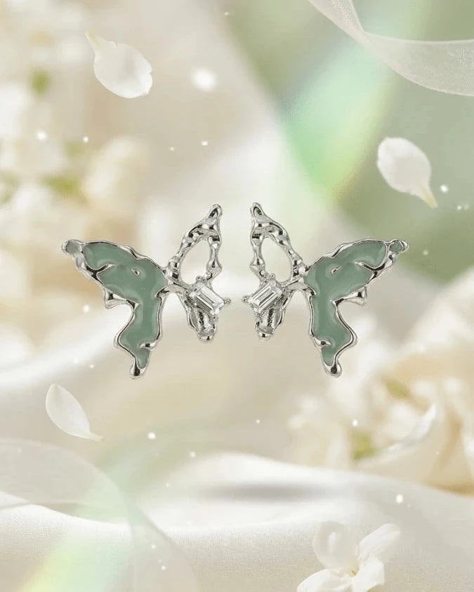 Silver butterfly shaped earring studs with green colour