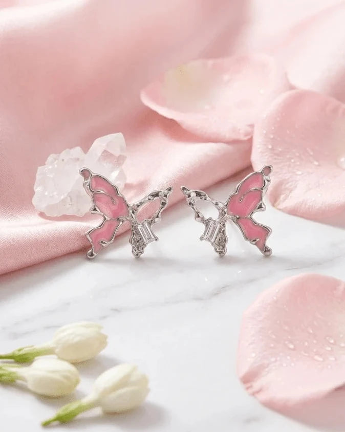 Silver butterfly shaped earring studs with pink colour