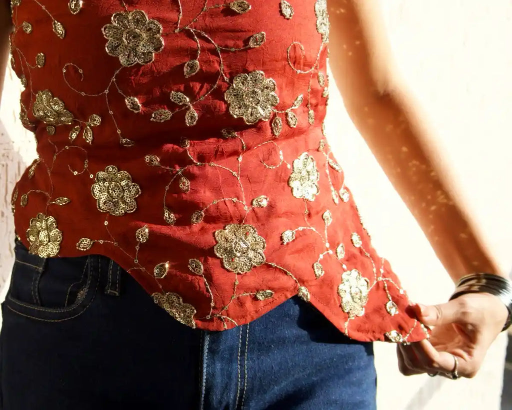 Close-up of rust Y2K top fabric and waistline detail 
